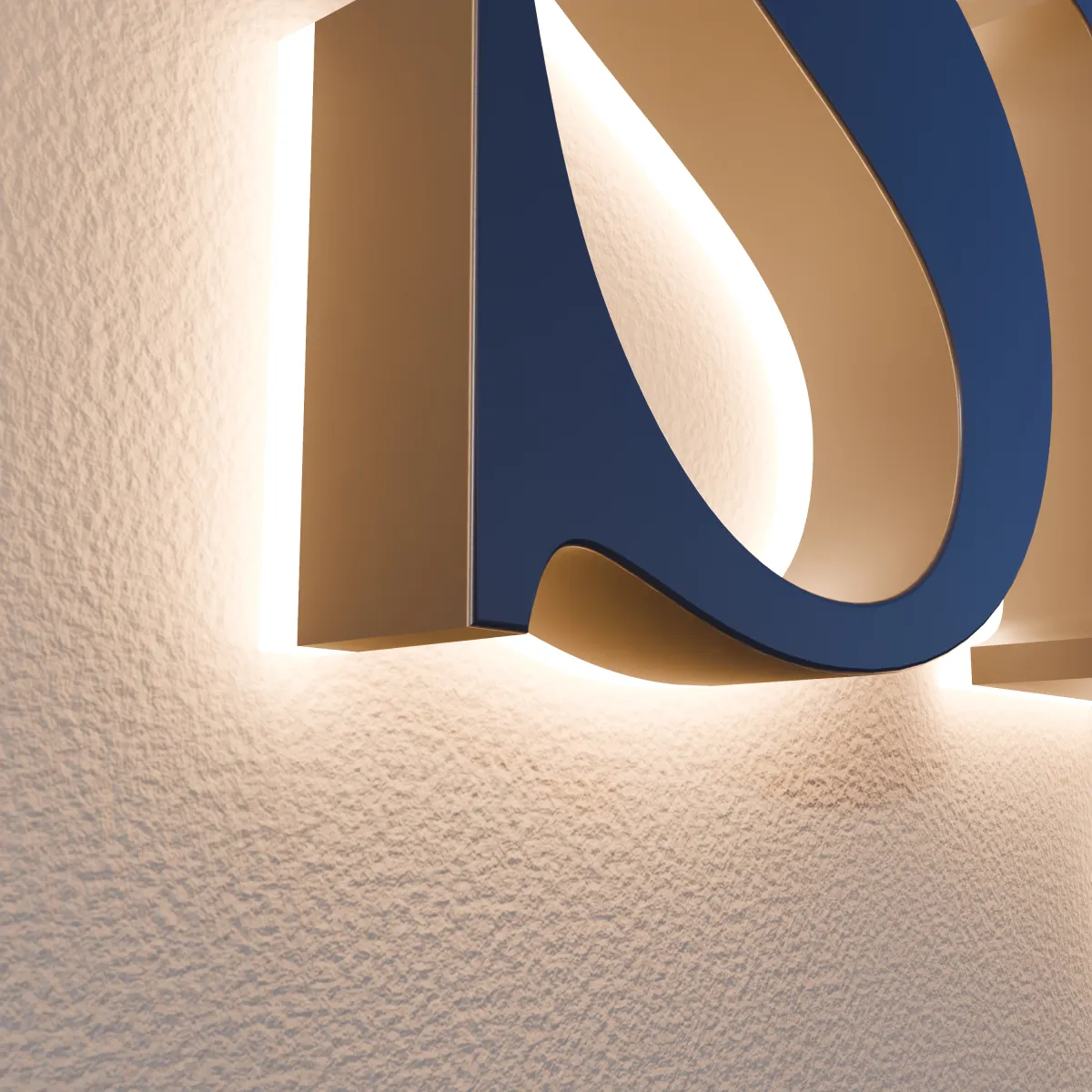 Light from the acrylic back of a navy halo-lit letter glowing on the wall around it