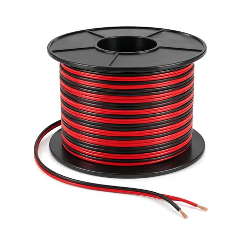 Carrete de cable plano de bajo voltaje rojo y negro con las puntas de cobre peladas en el extremo suelto, fondo blanco