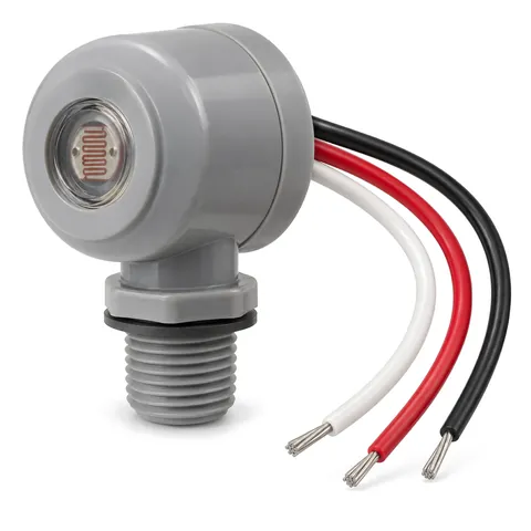 Round grey dusk-to-dawn photocell with a clear sensor window, threaded stem and black, red and white leads, on white