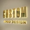 3D metallic letters "CUSTOM LOGO DESIGN" with backlit glow on a white wall.