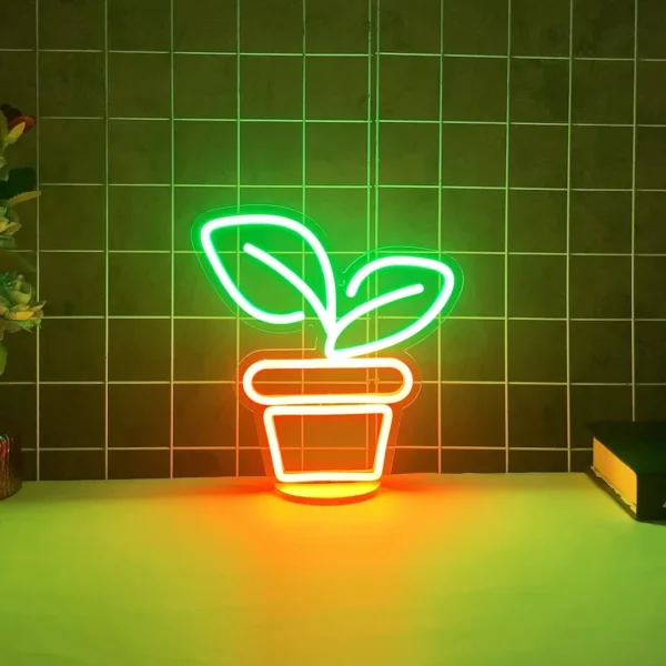 A desktop neon sign depicts a green-leaf plant and an orange flowerpot. The sign is placed on a desk, emitting vibrant light, and can be dimmed. It can also serve as a night light and an ambient light.