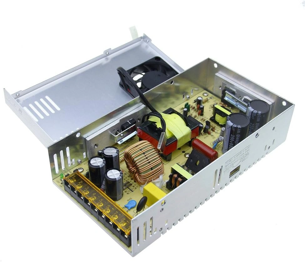 The interior view of a metallic power supply unit, revealing the internal components such as capacitors, coils, and circuit boards, essential for LED sign power regulation.