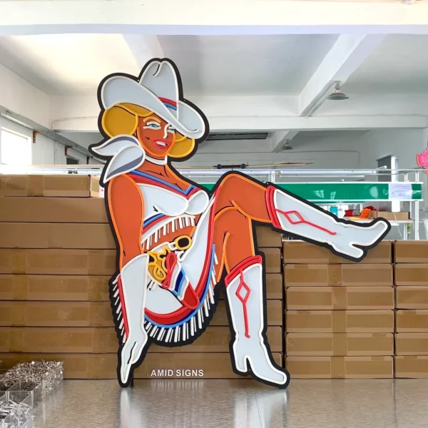 Daytime view of the cowgirl neon sign without the lights turned on, revealing the detailed design and colors of the cowgirl's attire, which include a white hat, white fringed outfit, and boots with red accents.