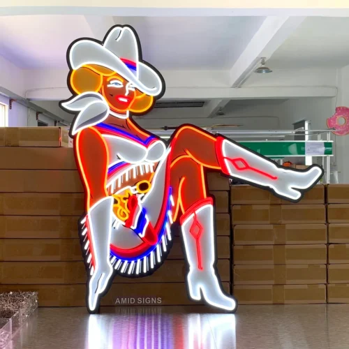 Neon cowgirl sign illuminated, showing bright red, white, and blue neon lights outlining the cowgirl's figure and clothing.