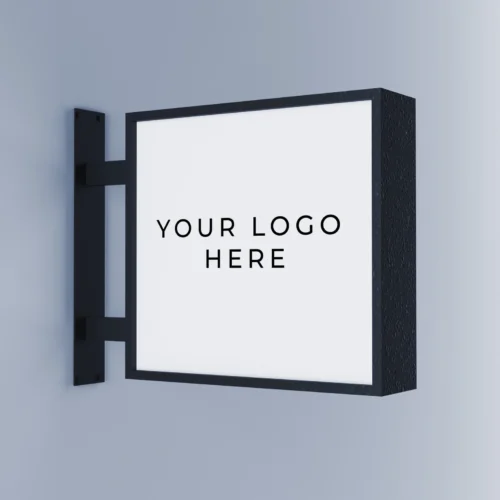 A wall-mounted, rectangular business sign with a blank white surface and black frame, displaying the placeholder text "YOUR LOGO HERE" in the center. The sign is affixed to a light gray wall using a sturdy black metal bracket. The design is simple and modern, suitable for various types of businesses looking for custom signage.